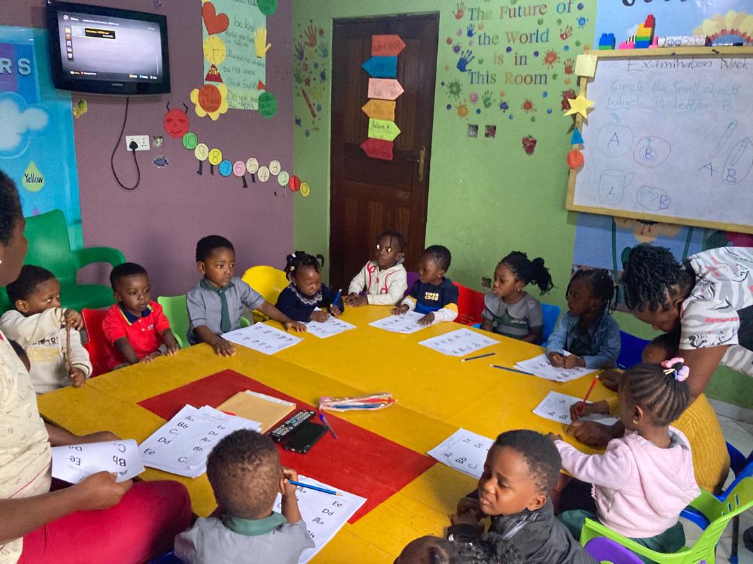 Children doing activities at a yellow table in a Sunshine Valley classroom
